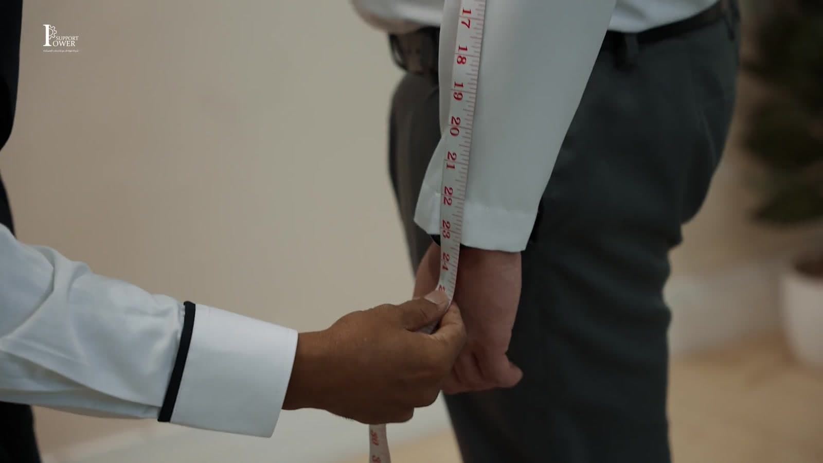 Power Support team member in branded uniform beside the company flag
